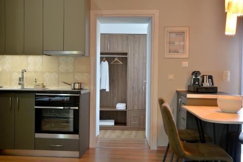 a kitchen with a table and a dining room at Sir T Residence in Flóka