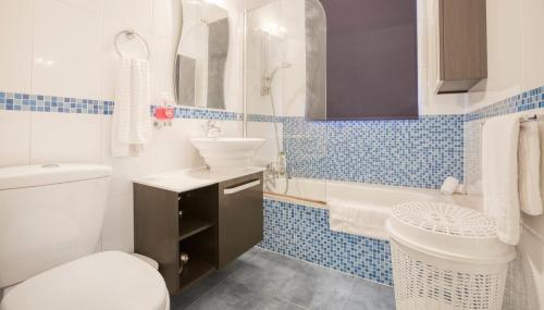 a bathroom with a white toilet and a sink at Comfort Double Room St. Julian's in Il-Gżira