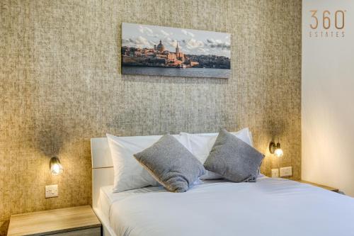 a bedroom with a bed with a picture on the wall at Authentic & Spacious 3BR home with Private Terrace by 360 Estates in Rabat