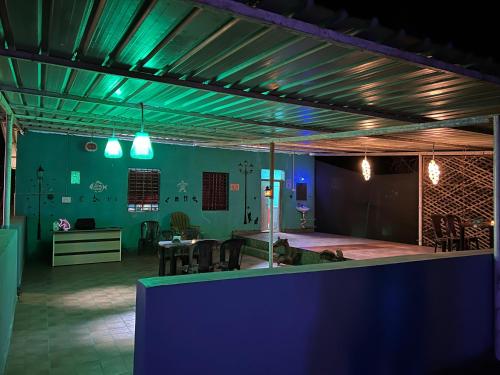 a room with a table and chairs and blue lights at Blue Lagoon Redefined in Gokarna