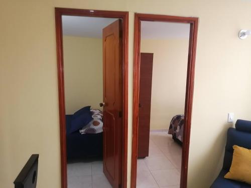 a room with a door leading to a bedroom at Apartamento a 20 minutos del aeropuerto in Bogotá