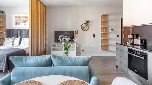 a living room with a couch and a bed at Lion Apartments - SCALA City Center Studio&Apartments IIC in Gdańsk