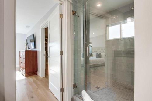 a bathroom with a shower with a glass door at North Shore in San Diego