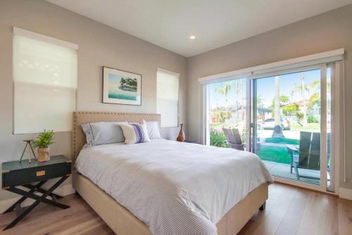 a bedroom with a large bed and a large window at North Shore in San Diego
