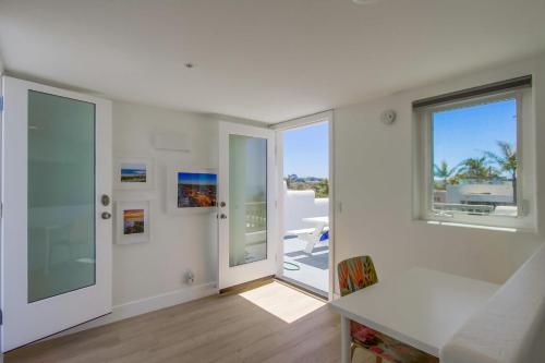 a white room with a view of a balcony at Ocean Oasis in Encinitas