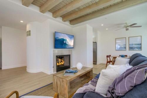 a living room with a couch and a fireplace at Ocean Oasis in Encinitas