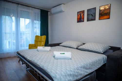 a bedroom with a bed with two towels on it at Studio apartman Daruvar in Daruvar