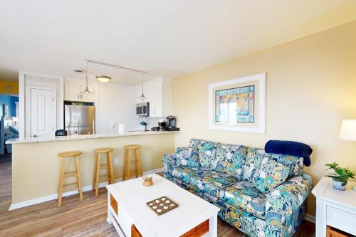 a living room with a couch and a table at CB05 Cozy Carolina Beach Condo in Carolina Beach