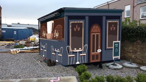 a tiny house with doors painted on it at Redcliffe Hotel in Inverness