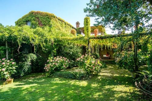 une maison recouverte de lierre avec une cour dans l'établissement Benvenuto Collection - Villa Mellicata, à Massa Lubrense