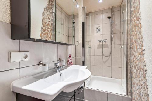 a bathroom with a sink and a shower at Haus Monterosa in Baden-Baden
