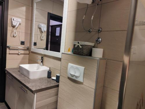 a bathroom with a sink and a mirror at Apartman Tiva - Milmari Resort-garažno mesto-GRATIS in Kopaonik