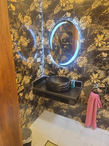 a bathroom with a sink and a mirror on a wall at Arizona luxury in Cairo
