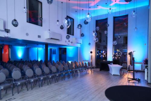 a room with rows of chairs and blue lights at Tulip Inn Żyrardów in Żyrardów