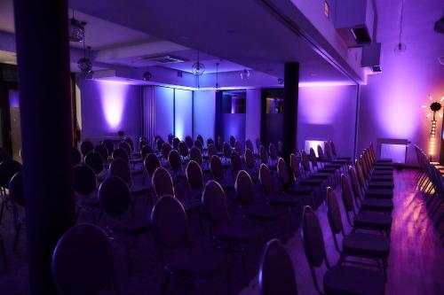 an empty room with purple lights and chairs at Tulip Inn Żyrardów in Żyrardów