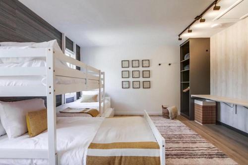 a bedroom with two bunk beds and a book shelf at Socal Style in Encinitas