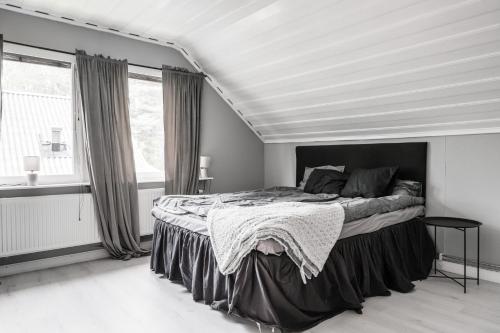 a bedroom with a large bed in a white room at Guestly Homes - 4BR Cozy House near windfarm in Piteå