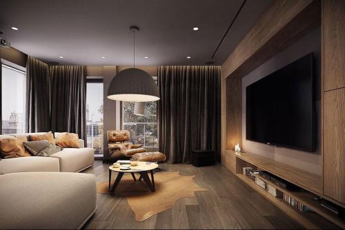 uma sala de estar com um sofá e uma televisão de ecrã plano em Luxary Home Marriot Marquis em Baku