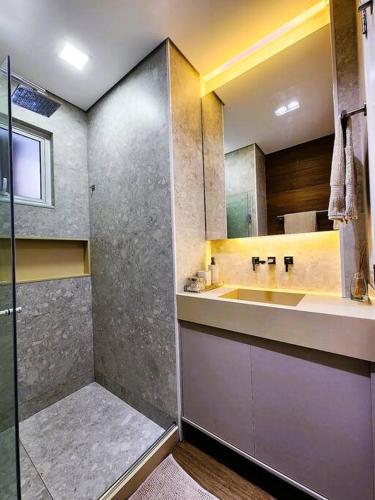 a bathroom with a sink and a shower at Ipagarden in Rio de Janeiro