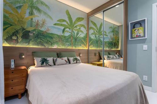 a bedroom with a large bed and a painting on the wall at Ipagarden in Rio de Janeiro