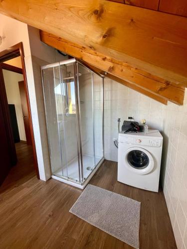 a washing machine and a shower in a room at Bnbook Expo Residence Rho in Rho