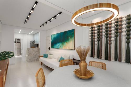 a living room with a table and a couch at Ipagarden in Rio de Janeiro