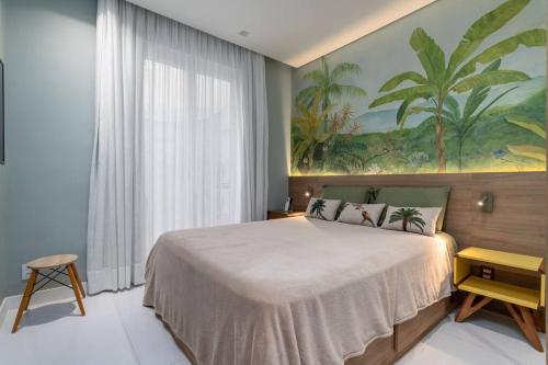 a bedroom with a large bed and a painting on the wall at Ipagarden in Rio de Janeiro