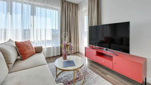 a living room with a large flat screen tv at Lion Apartments - SCALA City Center Apartments&Studio IIIC in Gdańsk