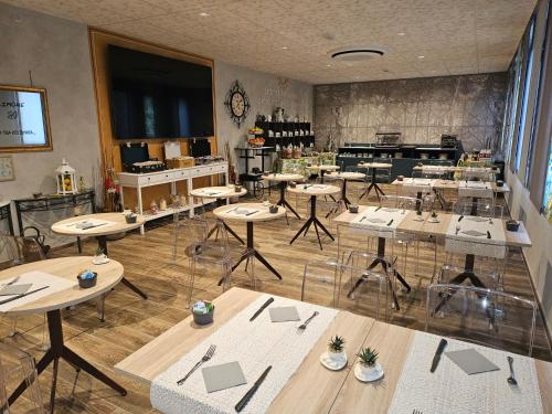 a restaurant with tables and chairs in a room at Hotel Euro in Castegnato