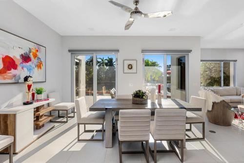 a dining room with a table and chairs at VILLA ST-BARTH Waterfront w htd pool by VIAC in Fort Lauderdale