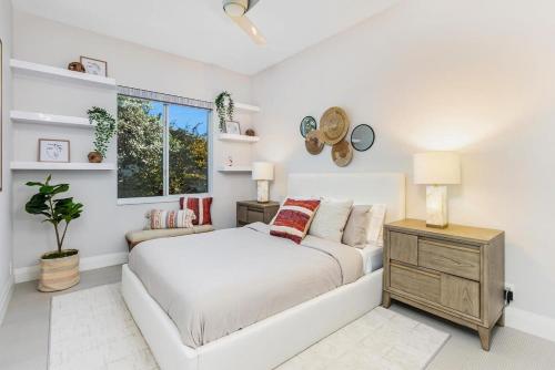 a white bedroom with a bed and a window at VILLA ST-BARTH Waterfront w htd pool by VIAC in Fort Lauderdale