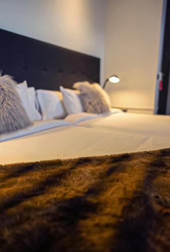 a bedroom with a bed with a lamp on it at Hotel Hita "Nature Experience" for all in Navacerrada