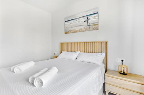 a bedroom with two white beds and a window at Sunshine in Pilar de la Horadada