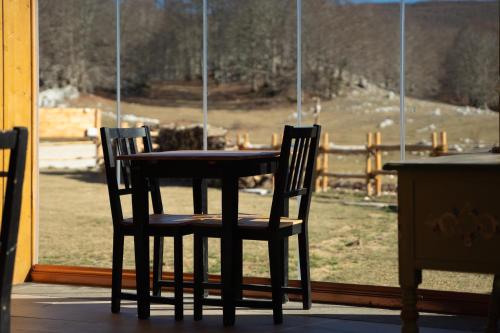a table and two chairs in front of a window at Campaegli resort in Campaegli