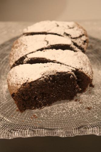 three pieces of chocolate cake on a glass plate at Hotel Touring in Ferrara