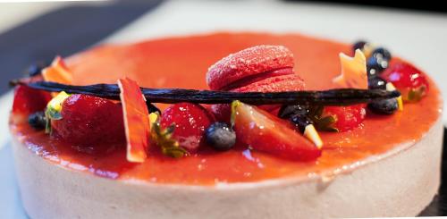 a cake with fruit on top on a table at Hotel Touring in Ferrara