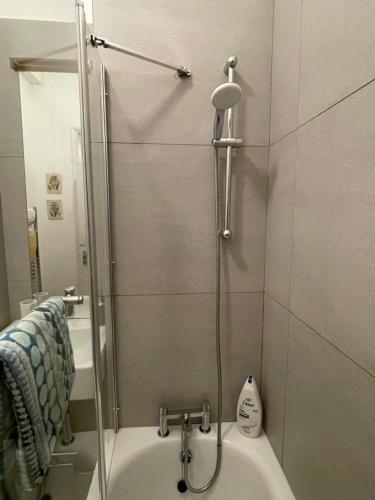 a bathroom with a shower and a bath tub at 10 min to The Heart of London - Zone 2 - Charming 2 bed Apartment in London