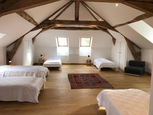 Zimmer im Dachgeschoss mit 2 Betten und einem Teppich in der Unterkunft Chateau de Tosny 