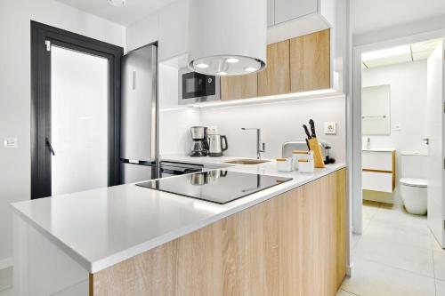 a kitchen with a white counter and a sink at Sunshine in Pilar de la Horadada