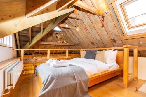 a bedroom with a large bed in a attic at Unique Detached House wPrivate Courtyard, London in London