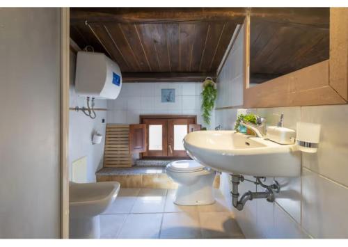 a bathroom with a sink and a toilet at SestraHome in Sassari