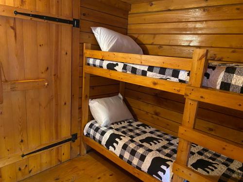a bedroom with two bunk beds in a cabin at Poolside Rustic Cabin with Amazing Views in Salisbury
