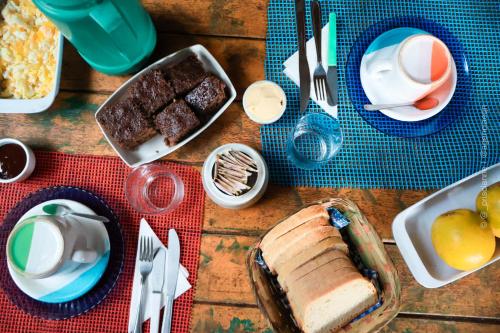 a table topped with a table with food and desserts at Pousada Roy Bonete in Ilhabela