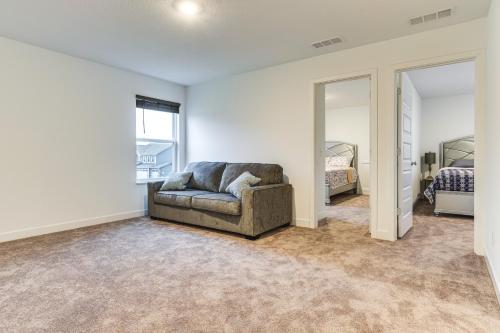 a living room with a couch and a mirror at Quiet Avon Home - Near Indianapolis Speedway! in Avon