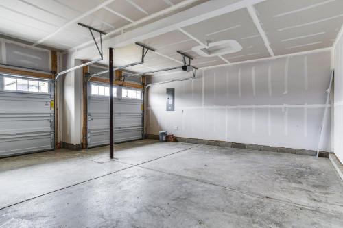 an empty garage with two garage doors in it at Quiet Avon Home - Near Indianapolis Speedway! in Avon