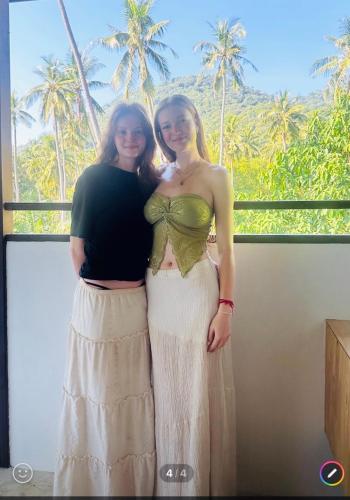 two women standing next to each other in front of a window at Koh Tao Silver Na’s Hostel in Koh Tao