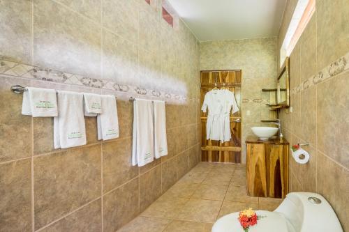 a bathroom with a sink and a toilet in it at Drake Bay Getaway Resort in Drake