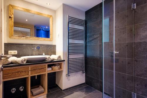 a bathroom with a sink and a shower at Hotel Tirol Fiss 4Sterne Superior in Fiss
