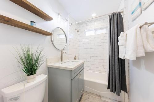 un bagno con un lavandino, una vasca e uno specchio di Pet Friendly Beach Bungalow, Close to Beach a Carlsbad