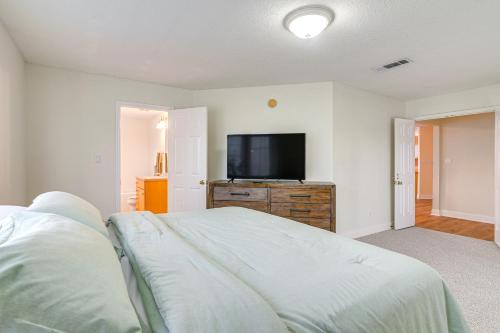a bedroom with a bed and a flat screen tv at Downtown Kemah Rental about 3 Blocks to Boardwalk! in Kemah